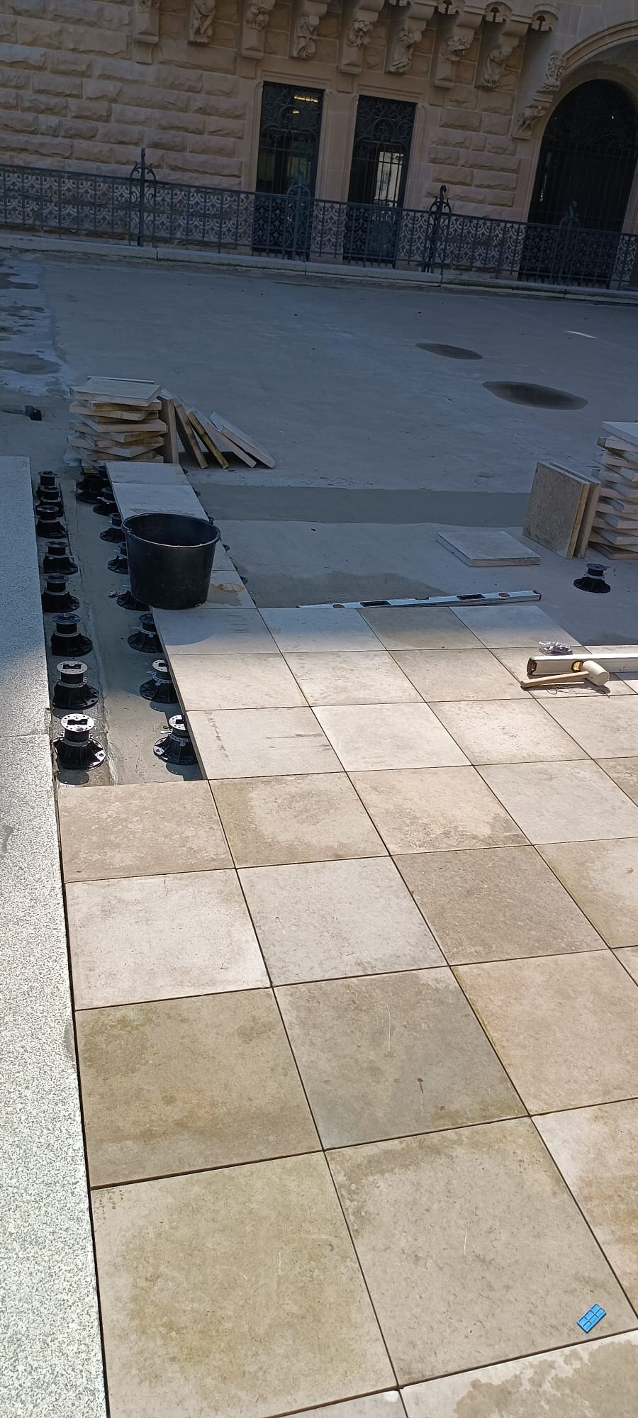 Montaje de terraza elevada sobre plots soporte en un patio interior
