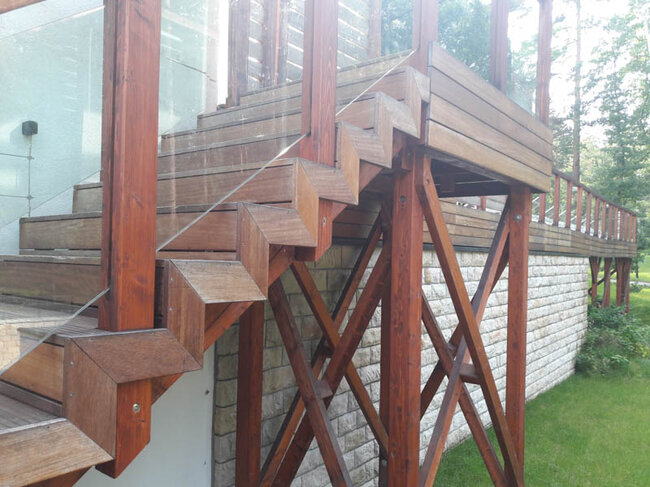Elevated wooden terrace on posts with external stairs