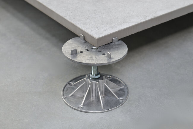 adjustable pedestal system supporting raised floor tile for